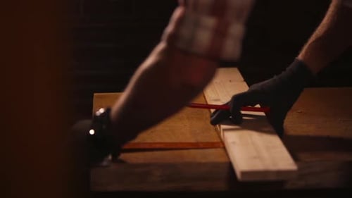 Person Measures and Marks Wood for Carpentry