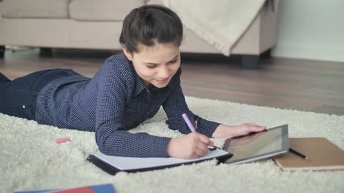 Girl Drawing and Writing on the Floor