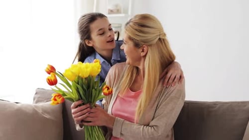 Loving Child Gives Mother Flowers as a Gift