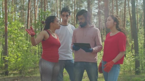Eco Activists Discussing Forest Garbage Cleaning