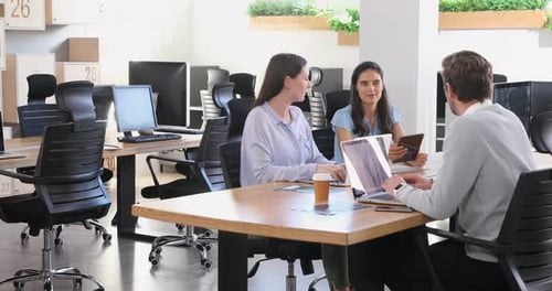 Executive discussing with each other while using laptop 4k