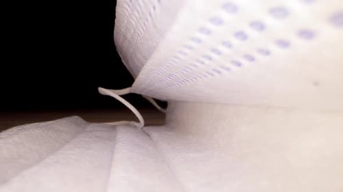 Detailed Close Up of White Disposable Mask