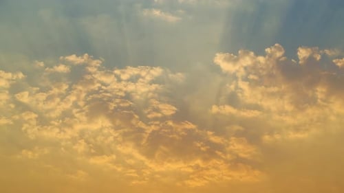 Vibrant Cloudscape Illuminated by Golden Sun Rays