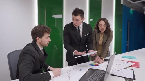 Business Meeting With Frustrated Man Throwing Paper