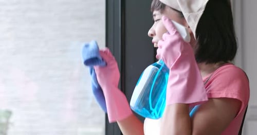 Woman Singing While Cleaning a Window