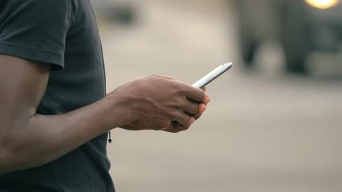 Hands Using Smartphone in Urban Environment