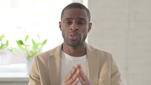 Confident Man Speaking Indoors to Camera