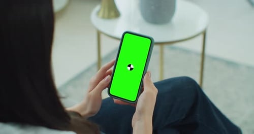 Female Using Phone While Sitting on Couch at Home