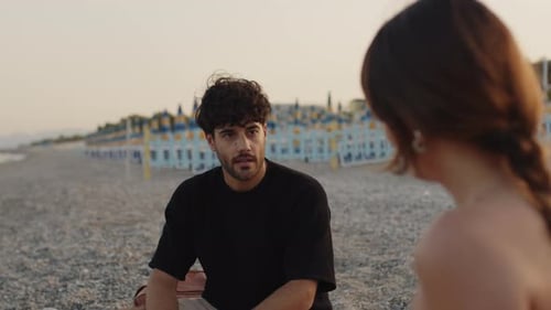 Young Couple Talking on the Sea Shore