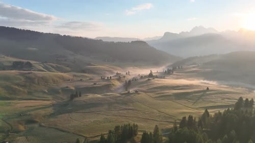 Sunrise in the Dolomites mountains with fog and mist