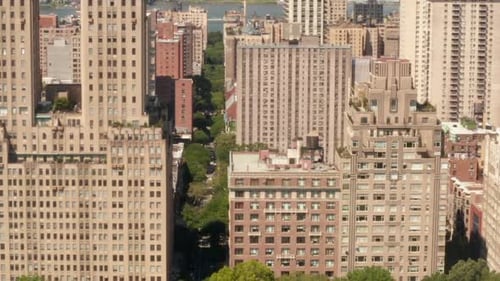 AERIAL: Flight Along Beautiful New York City Street at Central Park on Sunny Summer Day