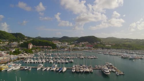 Aerial of boats moored at marina harbor on a sunny day, Le Marin