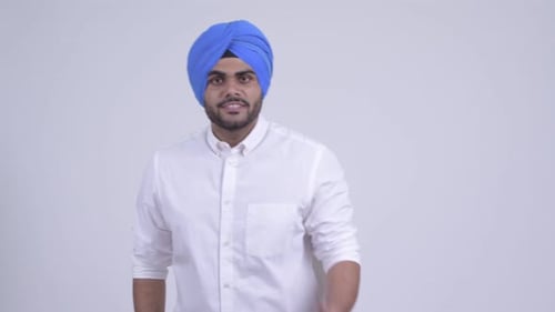Jeune homme sikh indien barbu en colère parlant agressivement et pointant la caméra