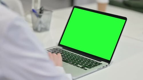 Woman Using Laptop with Green Chroma Screen Mock Up