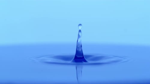 Water Droplets Create Ripples on Blue Surface