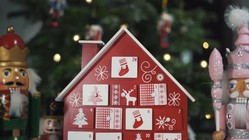 Wooden Tree Advent Calendar in Front of a Real Christmas Tree Decorated Nutcracker Soldier Toys.