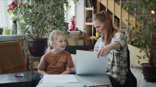Woman and Child Draw Together at Home