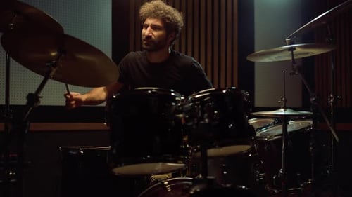 Happy Drummer Having Fun in Recording Studio. Happy Man Playing Drum Kit Indoor.
