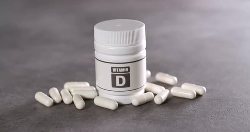 Vitamin D Supplement Bottle and Gel Capsules