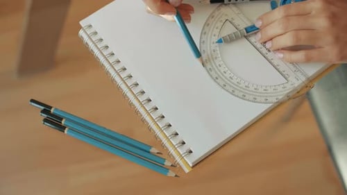Person Uses Compass and Pencil to Draw Design