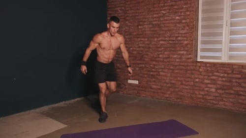 Muscular Man Doing Squats and Lunges Indoors