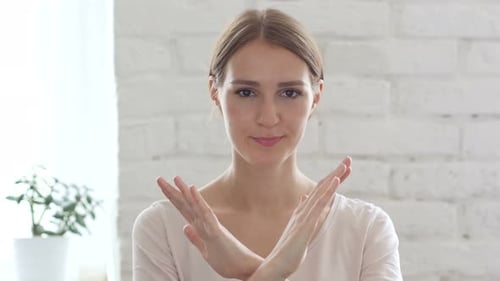 Woman Making Negative Gesture With Crossed Arms