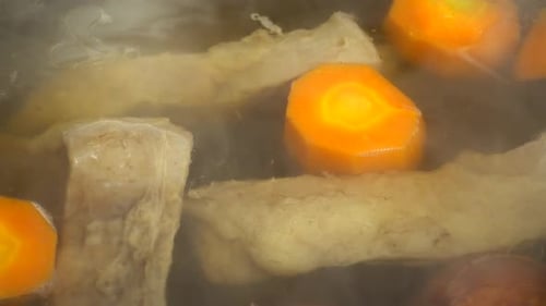 Pork Bones and Carrots Simmering in Water