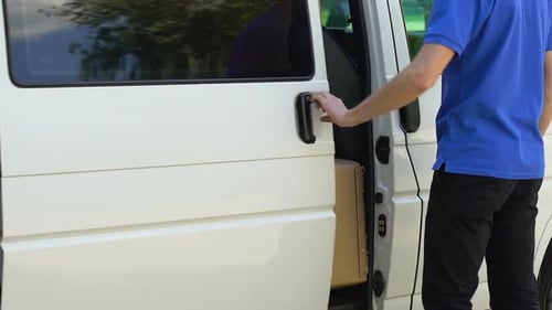 Delivery Man Opening Door of Company Car and Taking Parcel, Express Delivery