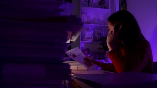 Asian woman working on laptop computer at home office. work overtime doing deadline project