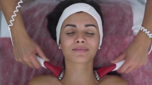 Woman Receiving a Facial Treatment at a Spa
