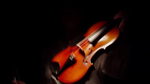 Violinist Playing Classically in Dramatic Lighting