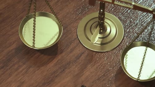 Brass Scale of Justice and Gavel on Wooden Table