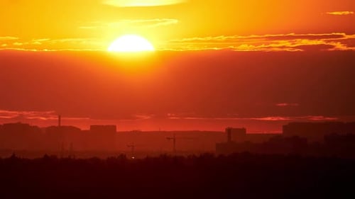 Evening sky with setting sun through clouds at sunset, cloudy landscape