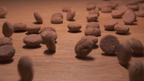 Brown Cookies Scatter Across Wooden Table