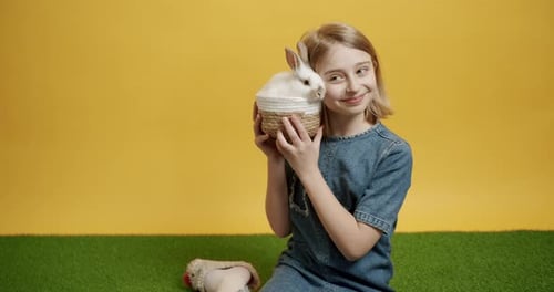 Girl Cuddles White Rabbit Pet in Basket