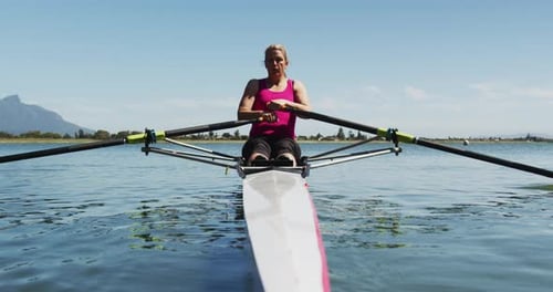 Senior caucasian woman rowing boat on a river