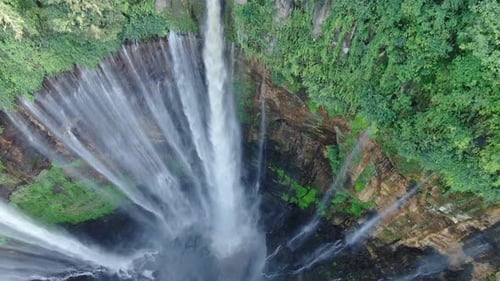 Aerial flight with drone above the famous Tumpak Sewu waterfall , Indonesia.
