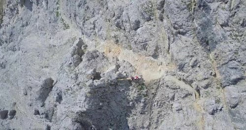 Aerial drone view of a man and woman couple hiking in the mountains