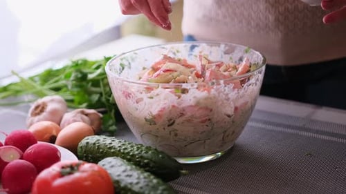 Adding Seasoning to Delicious Homemade Salad