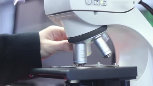 Microscope Lens Being Adjusted in a Laboratory