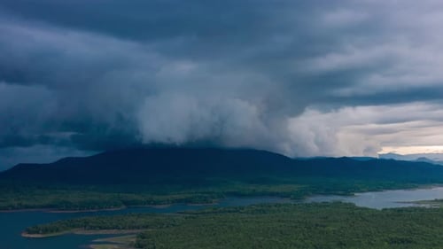 Rain storms and black clouds moving over the mountains.