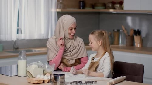 Woman and Girl Baking Together in Kitchen