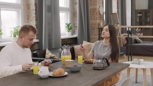 Young Couple Enjoying Breakfast at Home Together
