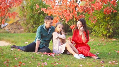 Family Together on a Leafy Autumn Day