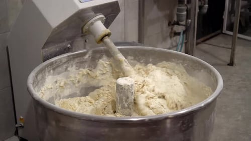 Industrial mixer for kneading dough. Mixing equipment in bakery.