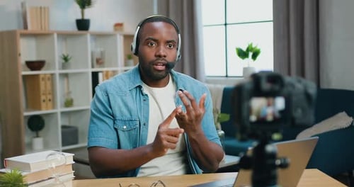 Man With Headset Records Vlog on Laptop