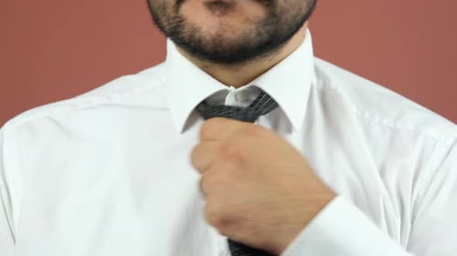 Man Tying Black and White Checkered Necktie