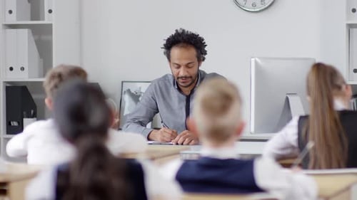 Charismatic Black Teacher Asking Questions in Class