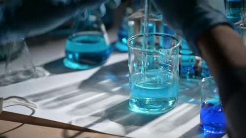 Scientist Mixing Solution in Beaker in Laboratory