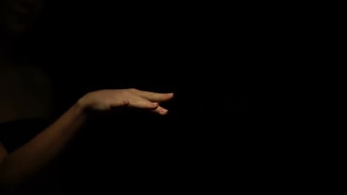 Man in Suit and Woman Stroking Hands Isolated on Black Background, Relationship